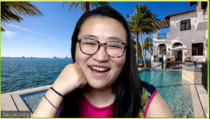 Dieyun smiling with a greenscreen background of a fancy swimming pool
